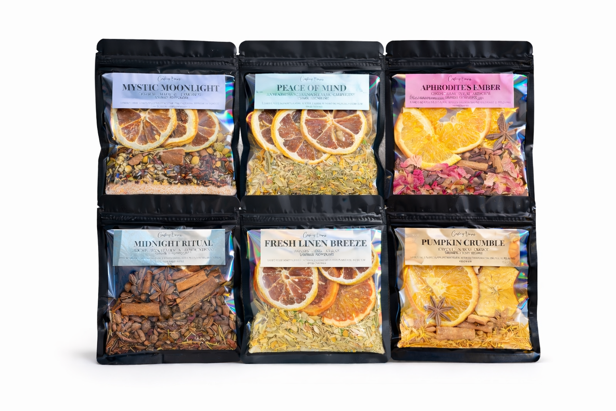 Six stand-up pouches of loose-leaf herbal tea blends arranged in two rows on a white background. The top row reads Mystic Moonlight, Peace of Mind, and Aphrodisiac Ambler; the bottom row reads Midnight Ritual, Fresh Linen Breeze, and Pumpkin Grounder.